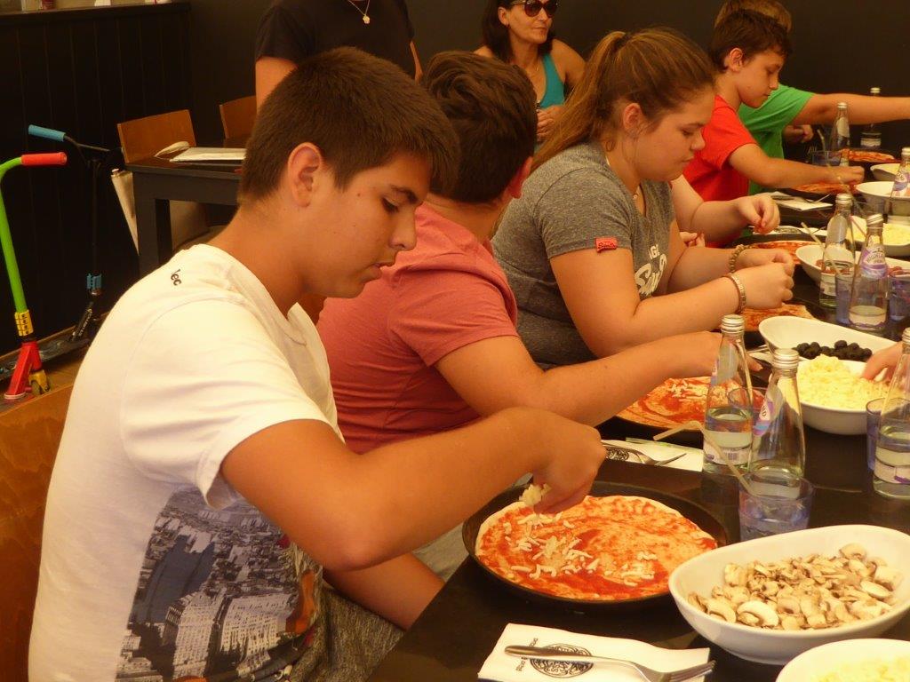 Youth club members take paddle boarding and pizza-making lessons
